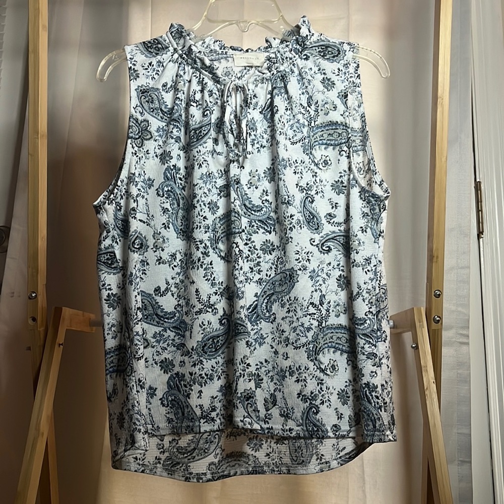 Floral tank top with draw sting around neck line area and flowy bottom.